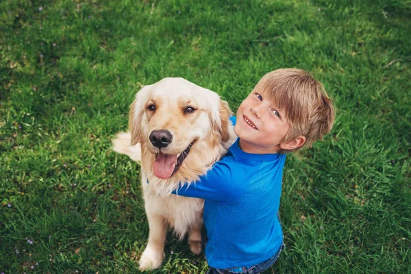 Boy Cuddling His Golden Retriever Dog — Stock Photo, Image