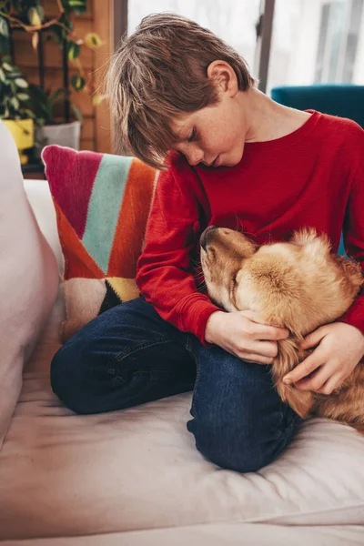 Boy Cuddling His Golden Retriever Dog Couch — Stock Photo, Image