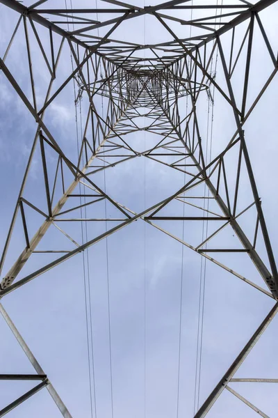 stock image Electricity tower seen from below and blue sky.