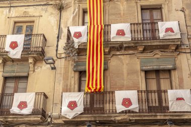 Detail facade balcony decorated,catalan flag and city shield,Reus,Catalonia,Spain. clipart