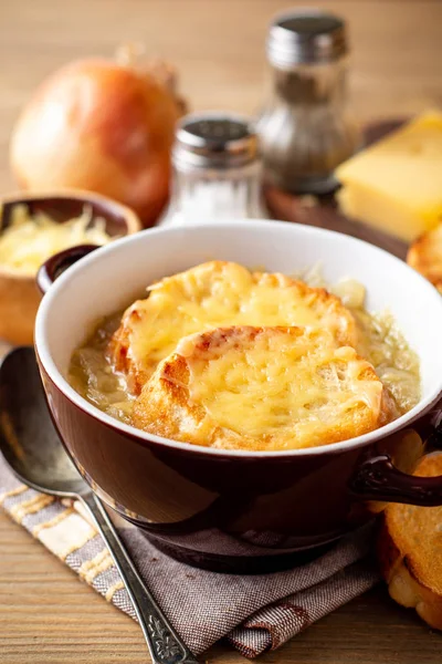 Fransız soğan çorbası ile kruton ve peynir rustik ahşap masa üzerinde. Seçici odak.