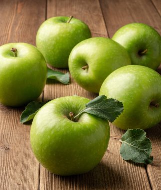 Kırsal ahşap arka planda taze yeşil elmalar. Seçici odak.