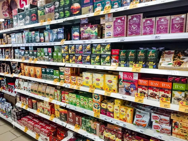 Saratov / Russia - January 2, 2019: Goods on the shelf of a grocery store. Tea and coffee in cardboard boxes on the shelves.