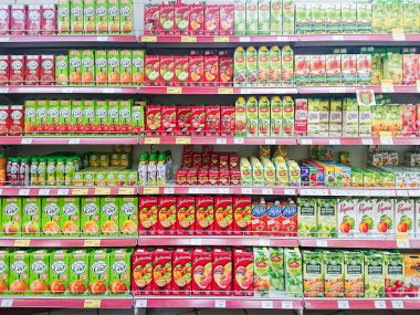 Saratov / Russia - January 2, 2019: Goods on the shelf of a grocery store. Juices and nectars in cardboard boxes. clipart
