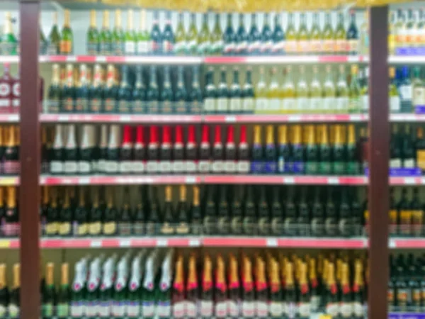 Blurred abstract image. Goods on the shelf of a grocery store. Sparkling wine and champagne.