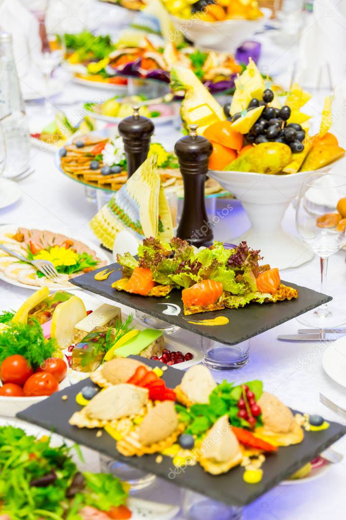 Delicacies, snacks and fruit on the festive table in the restaurant. Celebration. Catering. Banquet table.