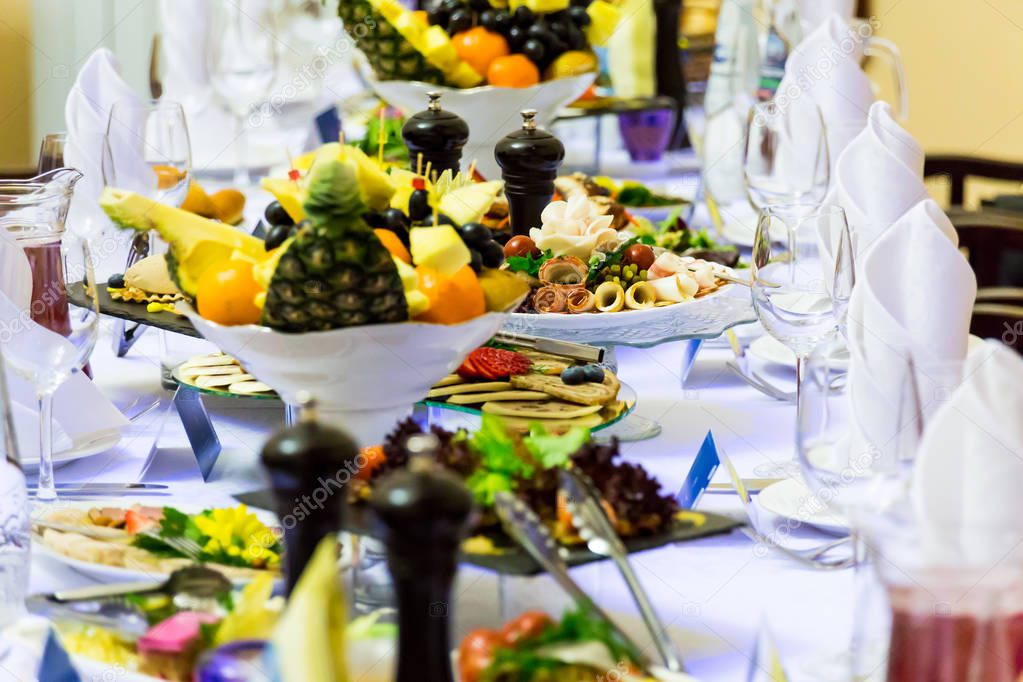 Delicacies, snacks and fruit on the festive table in the restaurant. Celebration. Catering. Banquet table.