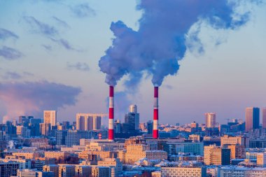 Thermal power plant in the center of Moscow in the winter evening. clipart