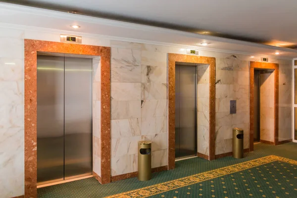 Three elevators in the hotel lobby. The interior of the building.