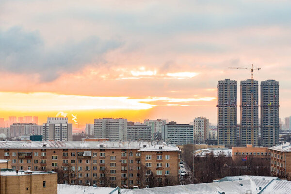 Construction of high-rise residential buildings in the big city. Winter cityscape at sunset . Moscow, Russia