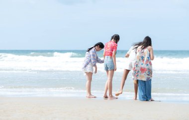 Happy children playing together in the sea, enjoying a fun summer day at the beach with laughter and friendship