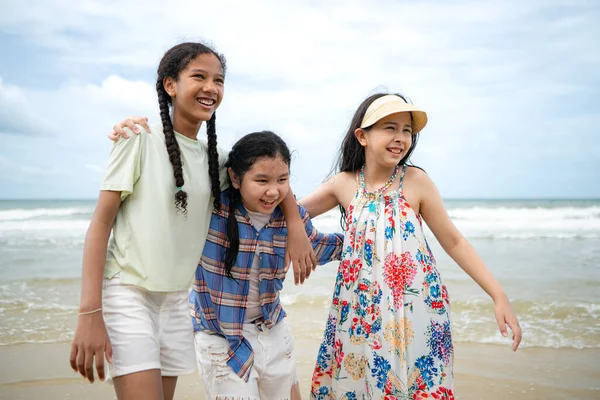 Happy children playing together in the sea, enjoying a fun summer day at the beach with laughter and friendship