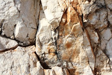 Ayrıntılı doğal kaya dokusu ince çatlaklar ve sıcak toprak tonları ile, jeolojik görseller, eğitim kaynakları, mineral kolleksiyonları veya doğal bir tasarım arka planı için ideal.