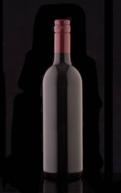 Siyah bir zemin üzerine kırmızı elit şarap şişe. Bir şişe şarap kırmızı bir tıpa ile silüeti.