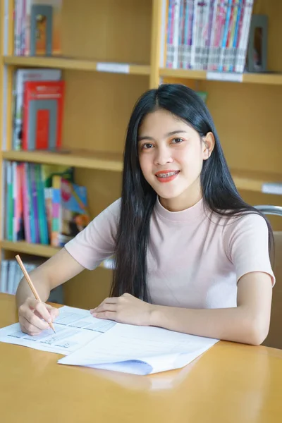 Young female university student concentrate doing language pract