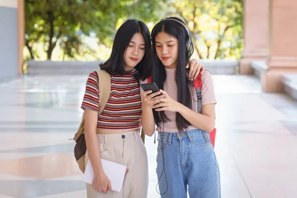 Asian university students chating, talking in university campus.