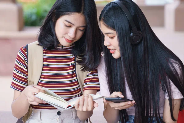 Asian university students chating, talking in university campus.