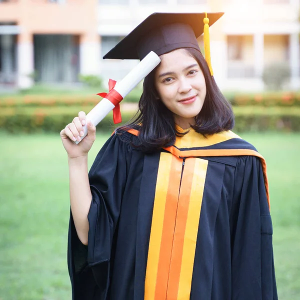 Young Asian woman university graduates celebrate with joyous and happiness with friends after receiving a university degree certificate in the commencement ceremony. Congratulations, graduation ceremony.