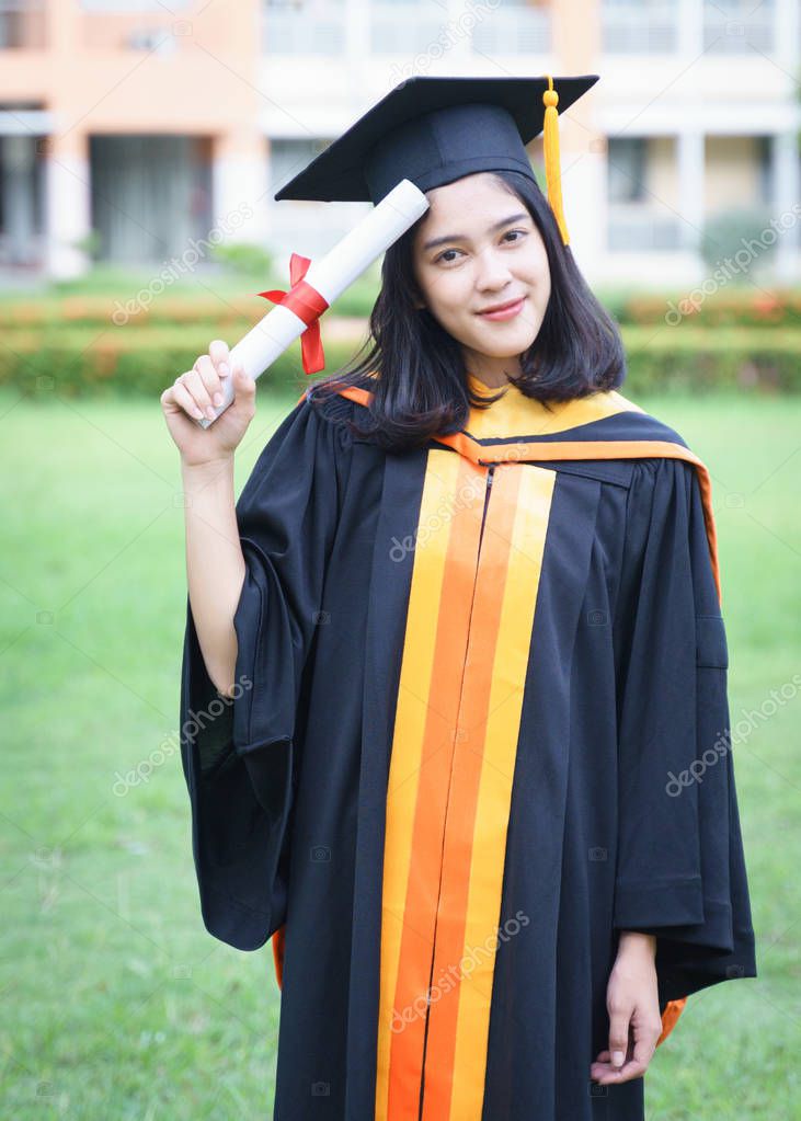 Young Asian woman university graduates celebrate with joyous and happiness with friends after receiving a university degree certificate in the commencement ceremony. Congratulations, graduation ceremony.