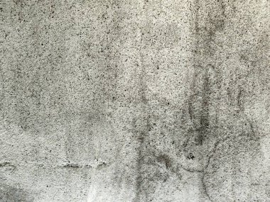 Eski beton duvarın dokusu. Açık gri çimento desenli beton duvar. Gri pastel, sert, çatallı çimento, beton, taş, sıva, alçıdan duvar. Boyanmış arka plan..