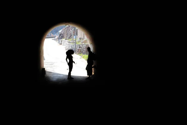 MONTENEGRO - JUNE 2012. Tired people resting at end of tunnel