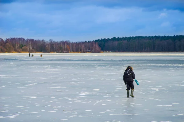 view of brave men on ice for winter fishing