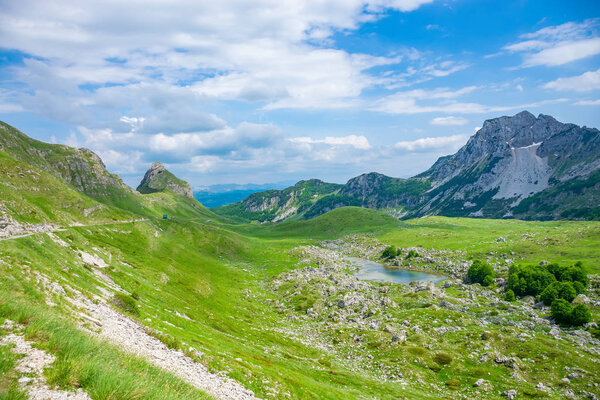 small blue mountain lake among high picturesque mountains