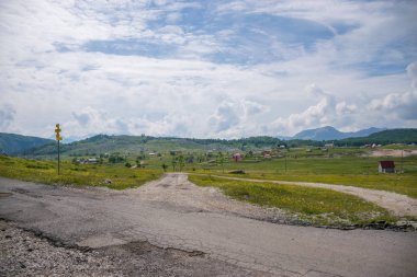 yeşil tepeler ve dağlar arasında küçük bir köy