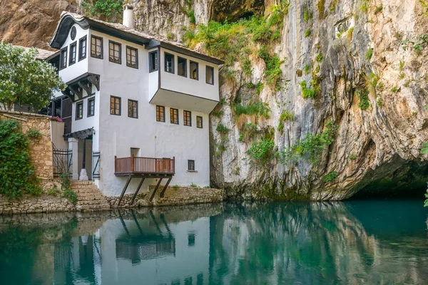 clean underground river emerging from cave near Islamic mosque