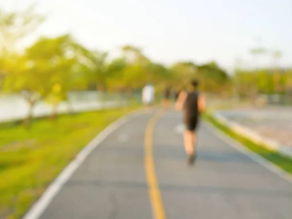 Blurred people jogging in the park — Stock Photo, Image