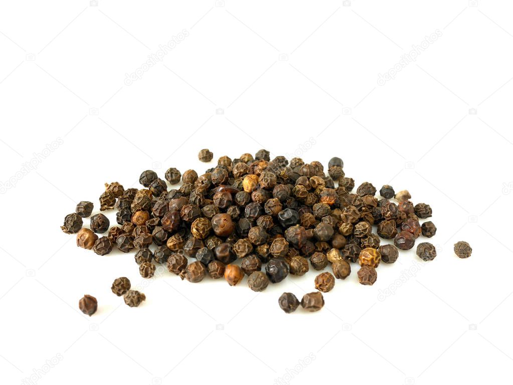 Pile of black peppercorns isolated on white background