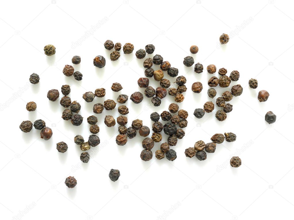 Pile of black peppercorns isolated on white background. Top view.