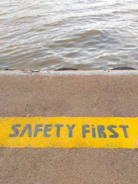 Safety first sign at the pier on Chao Phraya River in Bangkok, Thailand