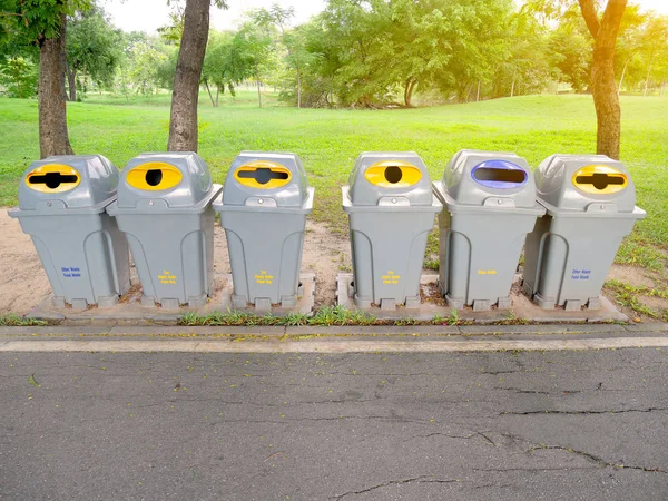 Rubbish bins in the park. Different types of trash.