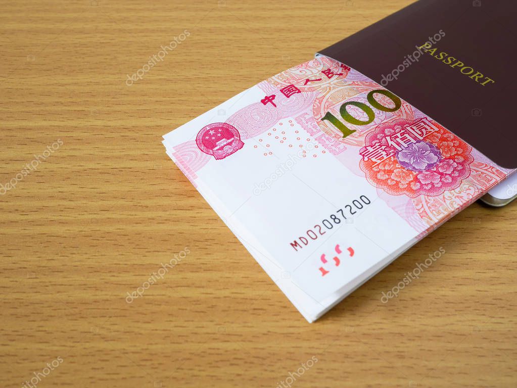 Stack of Chinese yuan banknotes money in passport