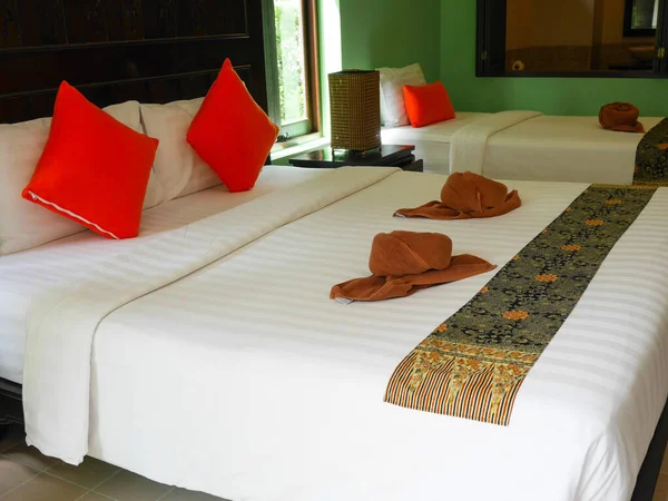 Decorative double bed and single bed in the resort