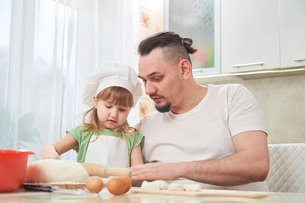 father preparing food with my daughter. a man teaches a child to