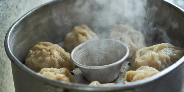 Uzbek national food manta, like dumplings, in a steamer, steamed