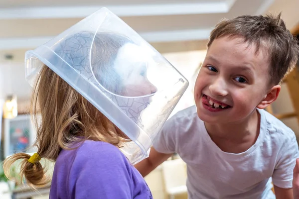children play hide and seek, hid in a transparent container