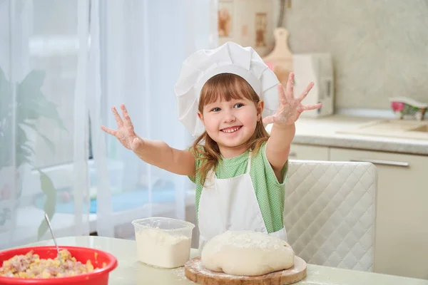 Cute laughing baby cook waving his hands, stretched out his hand — Stock Photo, Image