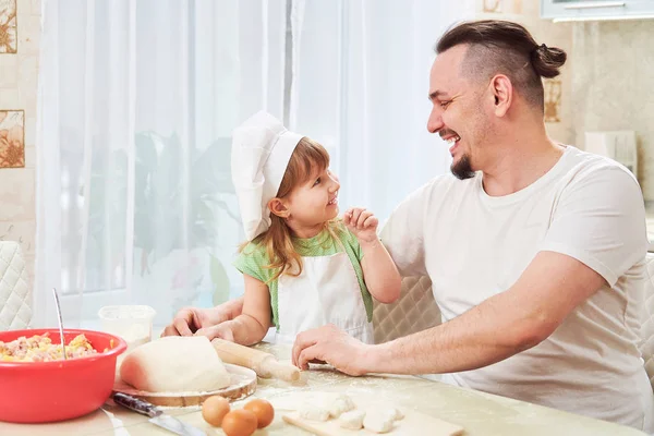 father preparing food with my daughter. a man teaches a child to