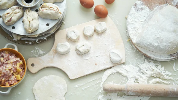 Uzbek national food manta, like dumplings, background of ingredi