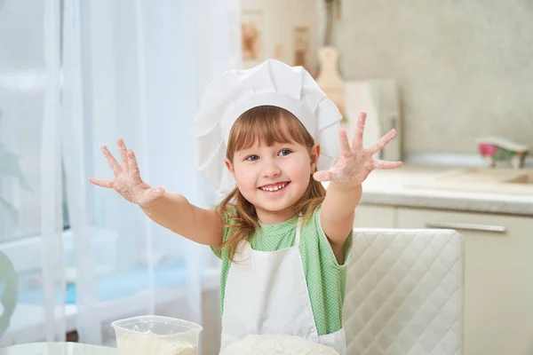 Cute laughing baby cook waving his hands, stretched out his hand — Stock Photo, Image