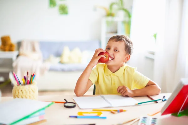 Estudiante en un descanso con placer comiendo una manzana roja . —  Fotos de Stock