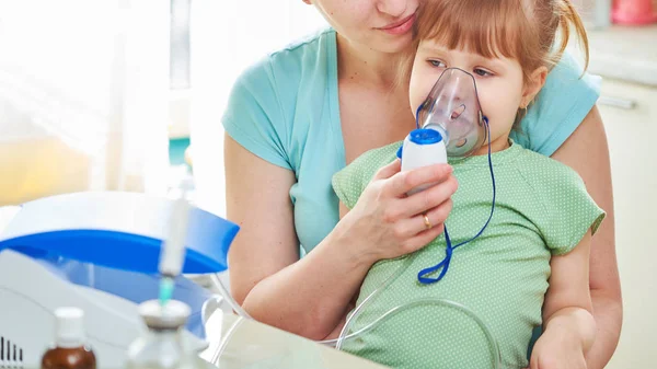 Medicina sobre la mesa. la chica respira a través de un nebulizador mas —  Fotos de Stock