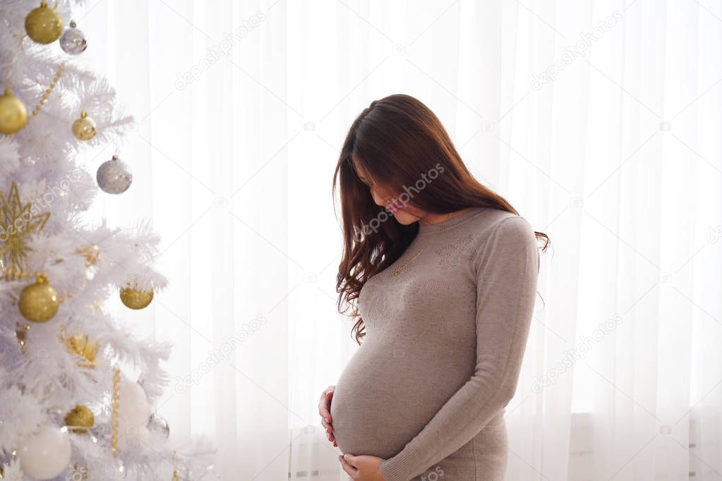 pregnant woman sitting on the bed