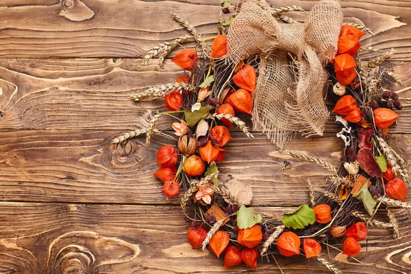 Autumn wreath made of natural materials. Cozy home decoration. Preparing for the holiday, Thanksgiving, and Halloween. Decoration, handmade accessories, autumn background made of natural elements.
