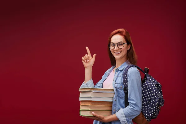 Молодая Привлекательная Положительная Студентка Очках Книгами Рюкзаком Направляет Внимание Указательным — стоковое фото