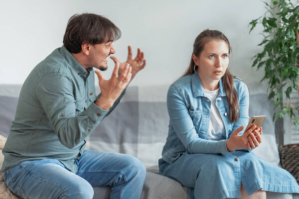 Spouses with relationship problems. Relationship problems, conflict, and the family concept-an unhappy couple arguing at home. family couple quarrels in a conflict at home