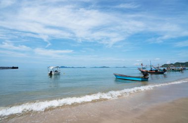 güzel sahne ile ahşap tekne mavi deniz ve mavi gökyüzü tropik Sahilde plaj beyaz kum üzerinde.